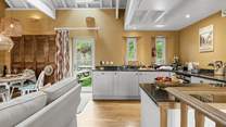 The open plan living area is on the first floor with a door to your own garden with picnic table.
