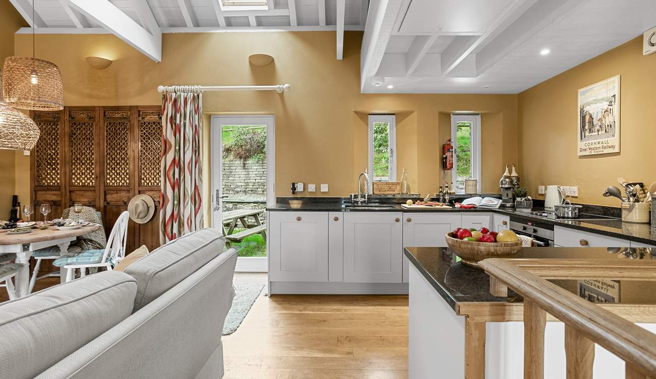 The open plan living area is on the first floor with a door to your own garden with picnic table.