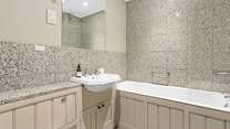 The family bathroom has both a shower and a bath, perfect for a long soak after a day of adventure.