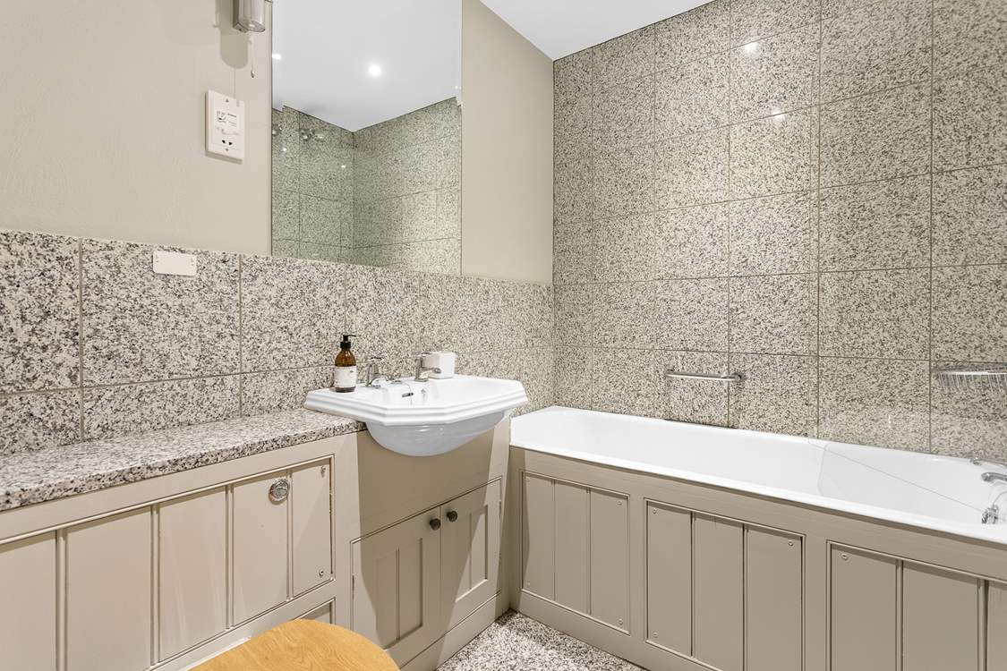 The family bathroom has both a shower and a bath, perfect for a long soak after a day of adventure.