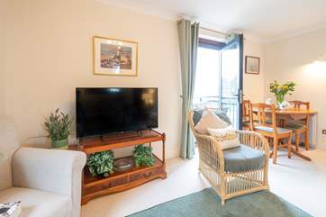 The sitting-room offers flexible accommodation with access to the balcony and somewhere to have a more formal meal if required.
