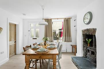 The farmhouse table and chairs invite everyone to gather round to chat about the day's adventures.