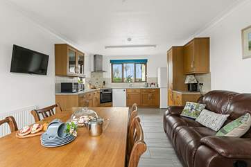 Relax on the comfy sofa in the kitchen/diner and catch up with the news on the Smart TV.