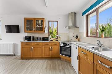 The kitchen/diner fills with light from dual-aspect windows.