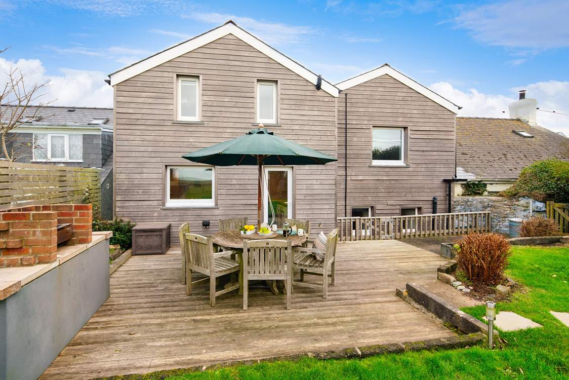 The outside area is a delight here, with a large deck for al fresco dining, a lawned area overlooking surrounding countryside to the sea, and a fabulous summer-house.
