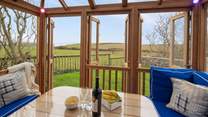 The fabulous summer house overlooks surrounding fields to the sea.