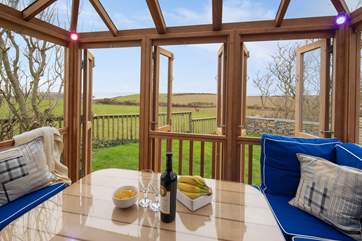 The fabulous summer house overlooks surrounding fields to the sea.