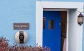 The blue door welcomes you, and there's a handy charging point for your electric car. - Thumbnail Image