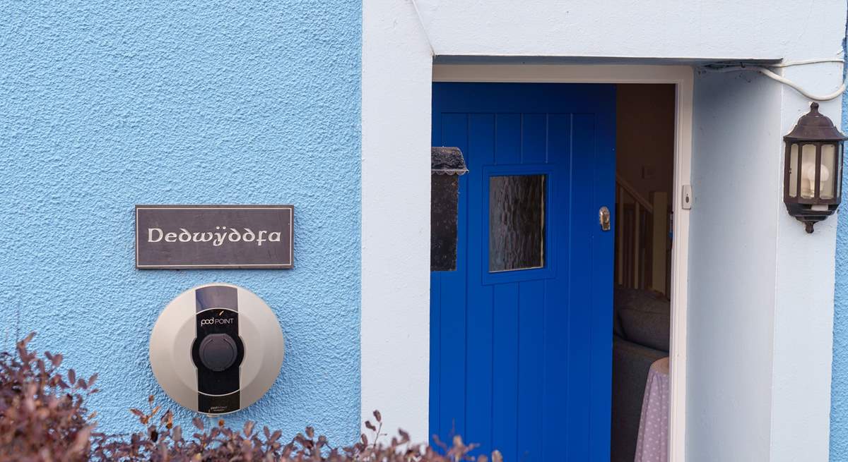 The blue door welcomes you, and there's a handy charging point for your electric car.