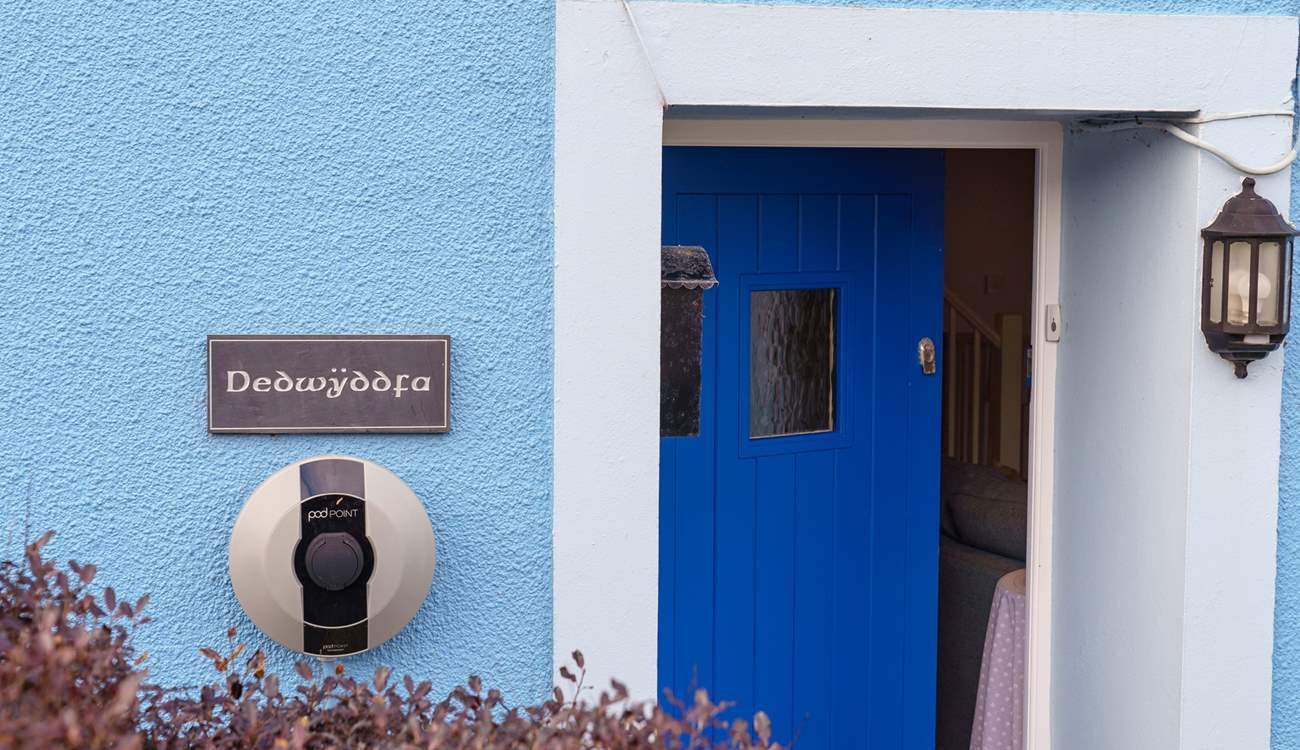 The blue door welcomes you, and there's a handy charging point for your electric car.