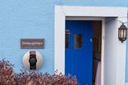 The blue door welcomes you, and there's a handy charging point for your electric car.