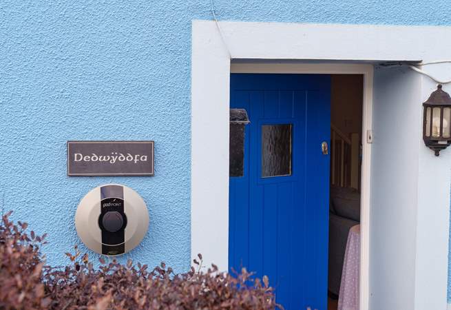 The blue door welcomes you, and there's a handy charging point for your electric car.