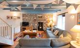 The main sitting-room has a cosy corner sofa, the perfect place to chill after a day on the beach. - Thumbnail Image