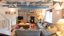 The main sitting-room has a cosy corner sofa, the perfect place to chill after a day on the beach.