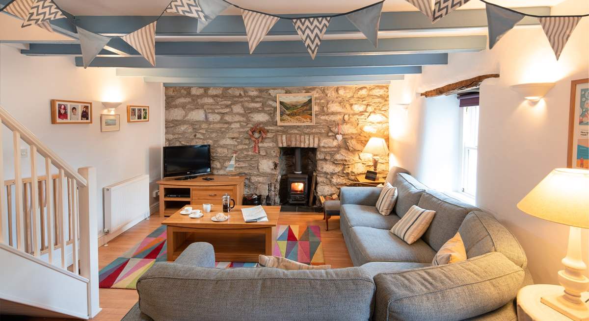 The main sitting-room has a cosy corner sofa, the perfect place to chill after a day on the beach.