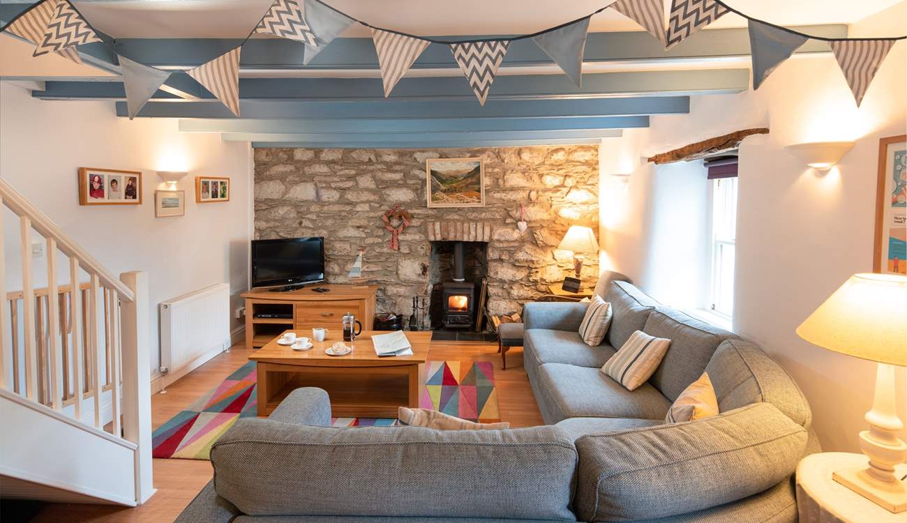 The main sitting-room has a cosy corner sofa, the perfect place to chill after a day on the beach.