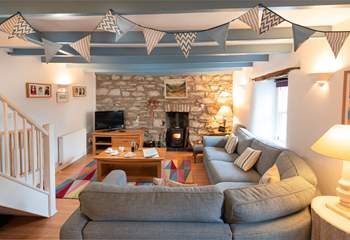 The main sitting-room has a cosy corner sofa, the perfect place to chill after a day on the beach.