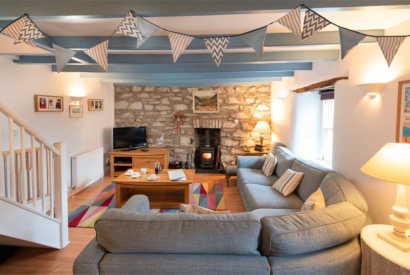 The main sitting-room has a cosy corner sofa, the perfect place to chill after a day on the beach.