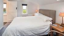 Bedroom 1 has a comfy king-size double bed and a dreamy outlook over the surrounding countryside to the sea.