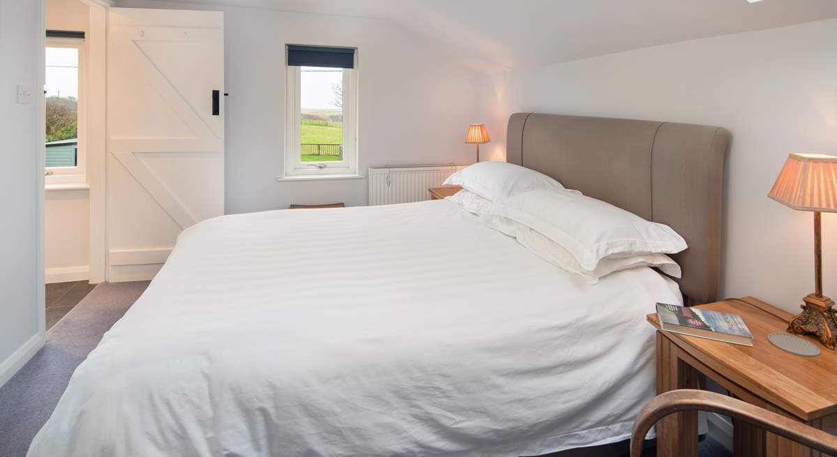 Bedroom 1 has a comfy king-size bed and a dreamy outlook over the surrounding countryside to the sea.