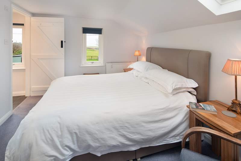 Bedroom 1 has a comfy king-size bed and a dreamy outlook over the surrounding countryside to the sea.