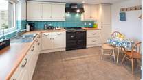 The spacious kitchen overlooks the large garden. Please note that the electric Aga has been replaced with an induction hob and electric oven.