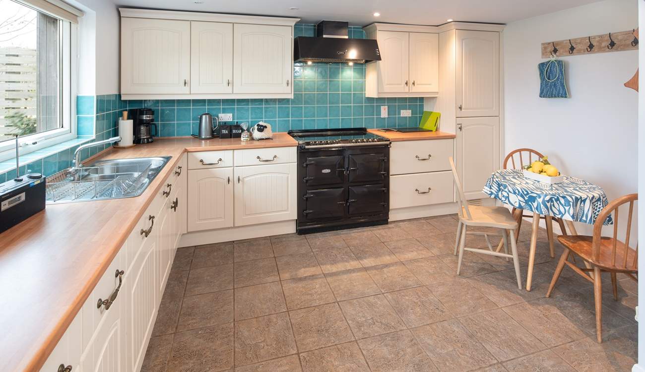 The spacious kitchen overlooks the large garden.