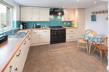 The spacious kitchen overlooks the large garden.