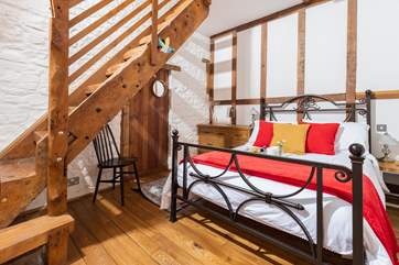 The gorgeous double bedroom is full of characterful woodwork; with a staircase leading to an attractive en suite. Be careful as you climb!