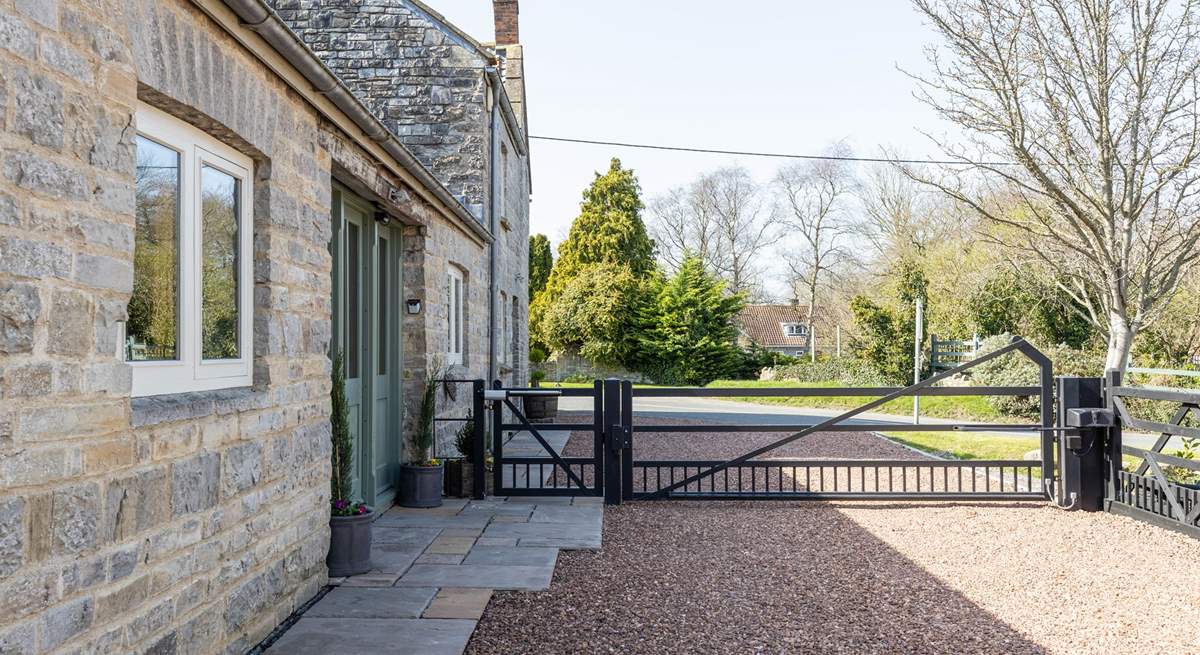 The gated driveway ensures privacy and secure parking. The neighbouring property is where the owners live.