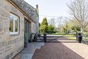 The gated driveway ensures privacy and secure parking. The neighbouring property is where the owners live.