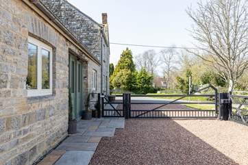 The gated driveway ensures privacy and secure parking. The neighbouring property is where the owners live.
