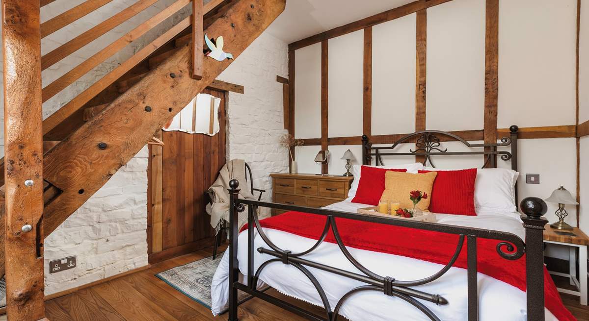 The gorgeous double bedroom is full of characterful woodwork; with a staircase leading to an attractive en suite. Be careful as you climb!