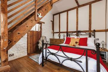 The gorgeous double bedroom is full of characterful woodwork; with a staircase leading to an attractive en suite. Be careful as you climb!