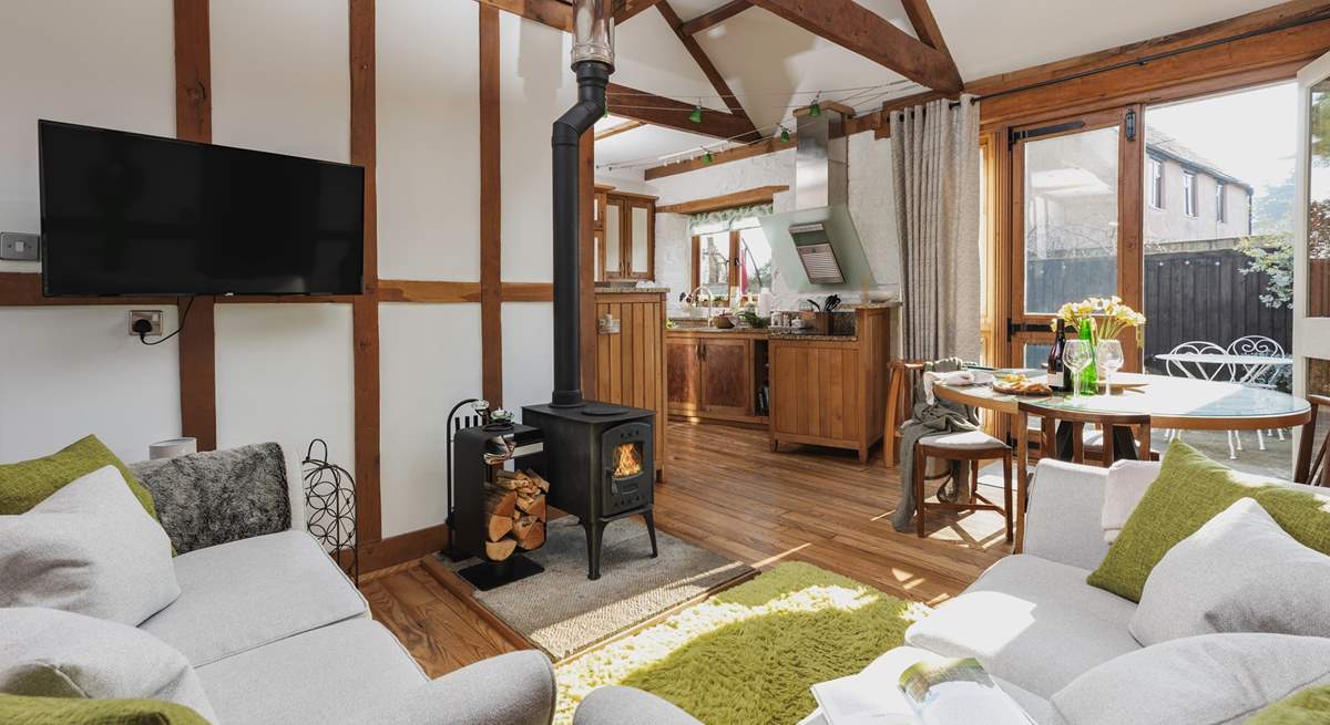 The open plan living space is light, bright and airy; but the comfy furniture and crackling wood-burner ensure that you can happily spend a cosy evening in.