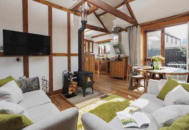 The open plan living space is light, bright and airy; but the comfy furniture and crackling wood-burner ensure that you can happily spend a cosy evening in.