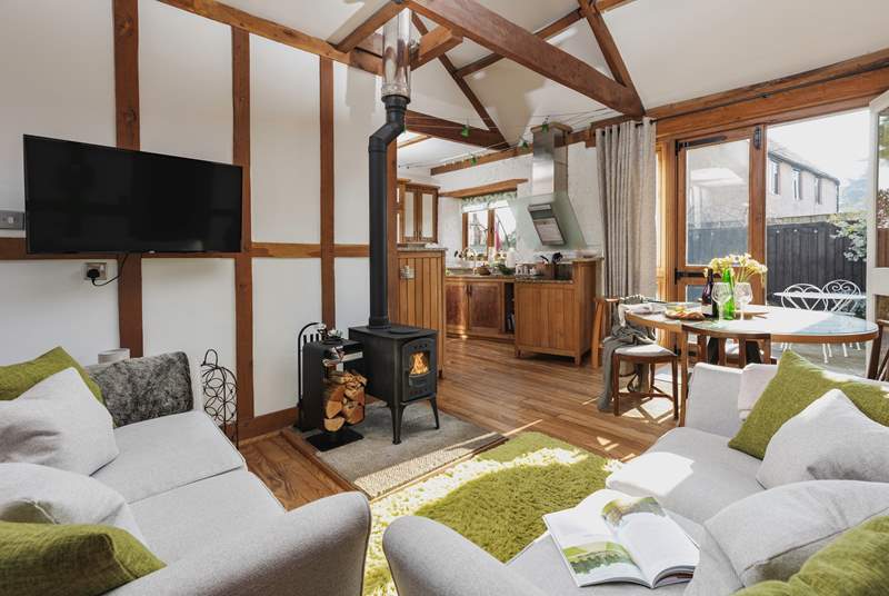 The open plan living space is light, bright and airy; but the comfy furniture and crackling wood-burner ensure that you can happily spend a cosy evening in.