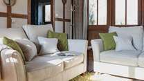 Cosy up on the comfy sofas and relax in the warm glow of the wood-burner.