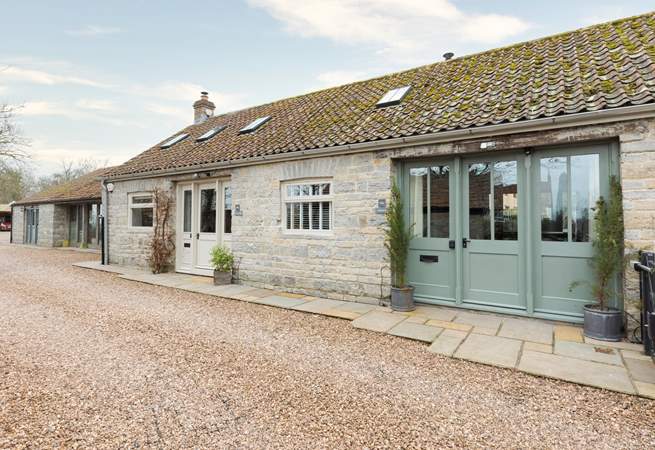 Welcome to Minstrels! With its charming rustic stonework and welcoming frontage. You can see the cream door leading to neighbouring The Smithy on the left.