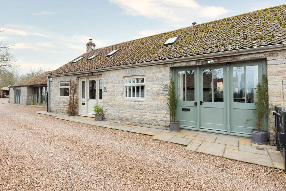 Welcome to Minstrels! With its charming rustic stonework and welcoming frontage. You can see the cream door leading to neighbouring The Smithy on the left.
