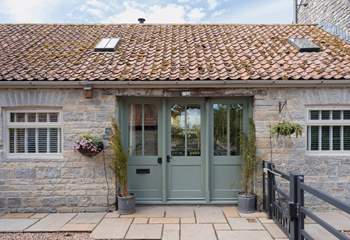Welcome to Minstrels! With its charming rustic stonework and welcoming frontage. You can see the cream door leading to neighbouring The Smithy on the left.