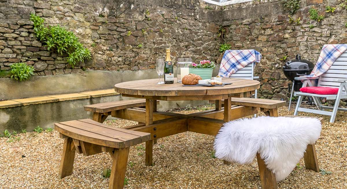 The secluded and sheltered garden lends itself perfectly to al fresco dining.