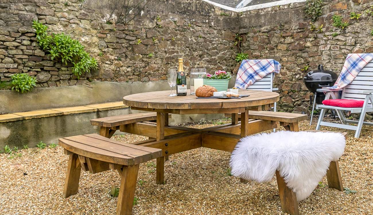 The secluded and sheltered garden lends itself perfectly to al fresco dining.