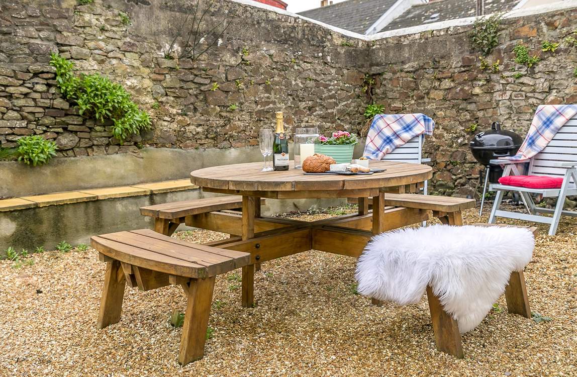 The secluded and sheltered garden lends itself perfectly to al fresco dining.
