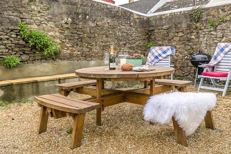 The secluded and sheltered garden lends itself perfectly to al fresco dining.