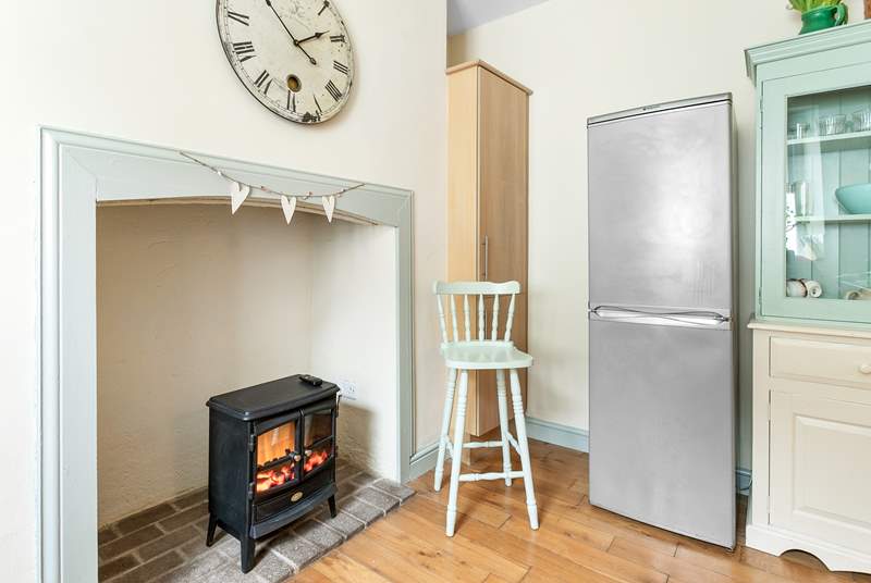 The original open fireplace is home to an electric wood-burner effect stove.
