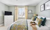 The dreamy double bedroom with a king-size bed is beautifully furnished in soft pastels. - Thumbnail Image