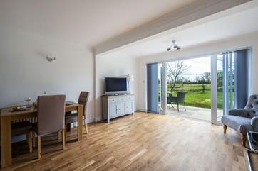 Sit back and enjoy views over the garden, fields and woodland.