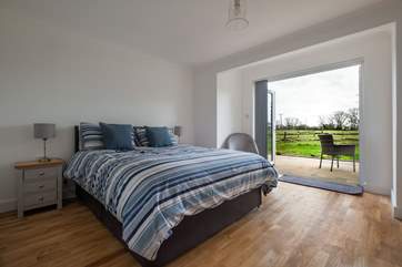 The spacious king-size double bedroom with countryside views.