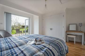 The bedroom is so spacious with a large wardrobe and a dressing table.